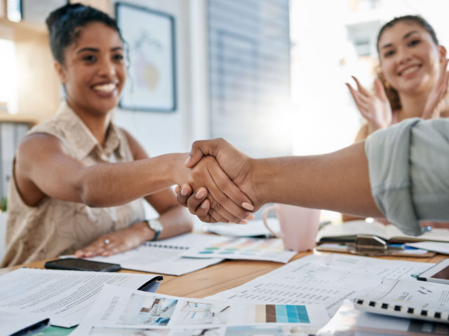 Meeting, handshake and collaboration with a business black woman in the office for a deal or agreement. Teamwork, collaboration and thank you with a female employee shaking hands with a colleague