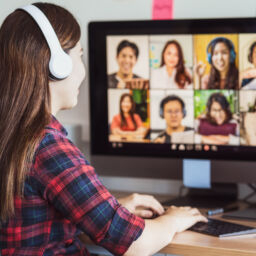 Rear view of Asian woman working and online meeting via video conference with colleague and team building when Covid-19 pandemic,Coronavirus outbreak,education and Social distancing,new normal concept