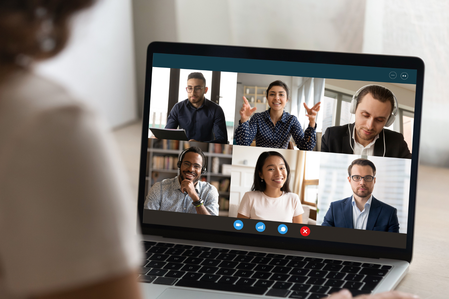 Corporate employee viewing a live online group language class on a laptop with six diverse participants engaging in a video call session